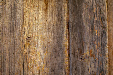 Old and worn wood texture in brown tones with knots and cracks ideal for backgrounds and various designs