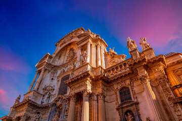 Impressive baroque facade of the Cathedral of Santa María de Murcia, Spain. Beautiful sunset sky.