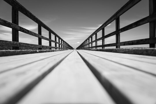 Long leading lines of never ending jetty from deck level on Motuihe Island , Auckland New zealand.