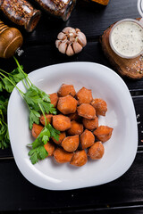 Traditional fried pelmeni, ravioli, dumplings filled with meat on black background, copy space.