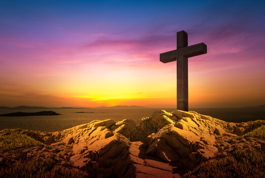 Death, crucifixion and resurrection concept. Christian cross at dusk.