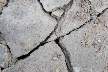 Cracked concrete texture background, gray texture with cracks close up.