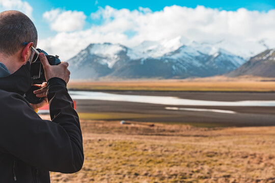 Man photographer and explorer in Iceland taking photos of beautiful landscape