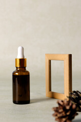 Skincare serum product with pure essential oils in bottle with dropper. Wooden frame product...