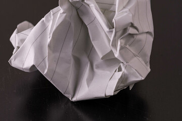 crumpled paper on black background