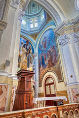 Guayaquil, Guayas, Ecuador - November, 2013: Interior of the Santo Domingo church (Saint Domingo), with its many decorations, statues, religious art, paintings, columns and stained glass windows