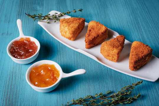 Camembert cheese fried in portions and presented with two flavored jams.