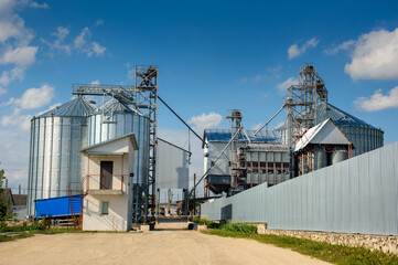 Fototapeta na wymiar Building Exterior, Storage and drying of grains, wheat, corn, soy, sunflower against the sky
