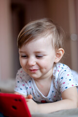 Fototapeta premium the child looks at the phone
