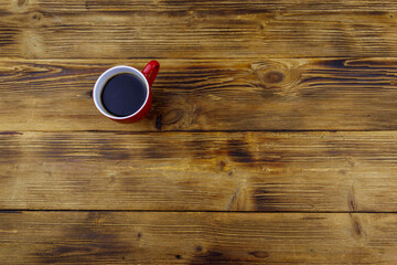 Cup of coffee on the wooden table. Top view, copy space