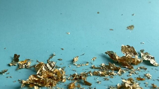 gold leaf - gold leaf falling and floating down to background in slow motion 