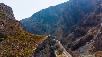 Empty rural road through the beautiful gorge of Kourtaliotikos in Crete Island in Greece.