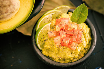 Avocado Tropical Tree Fruit, bowl with puree, tomato and lemon
