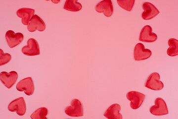 red hearts on a pink pastel background. Abstract background with paper-cut shapes. Sainte Valentine, mother's day, birthday greeting cards, invitation, celebration concept