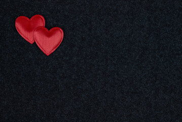 Red hearts on black background with copyright space for text