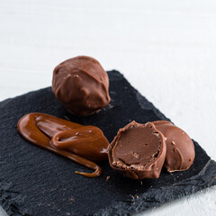 Melted caramel candies and caramel sauce with a salt on a white background. Close up