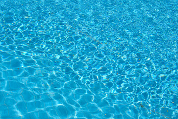Closeup surface of blue clear water with small ripple waves in swimming pool