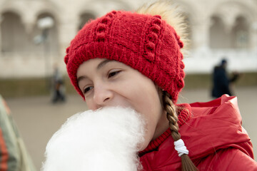 A cute girl with cotton candy. Childhood. Delicious.