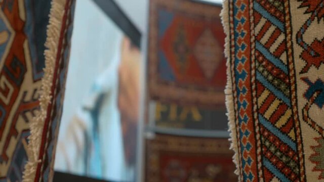 Beautiful handmade carpets from Asian countries are shown at the exhibition. Shot in motion. Closeup
