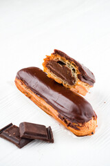 chocolate eclair, Traditional french dessert eclair with custard and chocolate icing