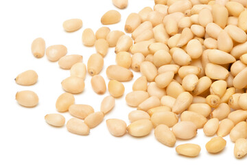 Peeled pine nuts isolated on white background. Healthy nuts snacks. Clipping path, full depth of field. Closeup view.