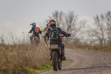 Fototapeta na wymiar a motor cyclist (biker) riding their off-road motorbike along a stone track on Salisbury Plain, Wiltshire