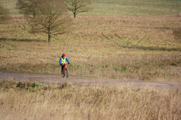 a casual cyclist on a stone track crossing salisbury plain, Wiltshire UK