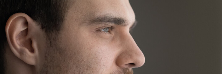 Wide image dreamy motivated man eyes cropped close up, panoramic banner confident dreamy businessman entrepreneur executive looking in distance, visualizing new opportunities, dreaming of success