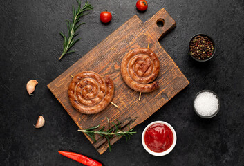 grilled sausages in the form of a spiral on skewers on a stone background