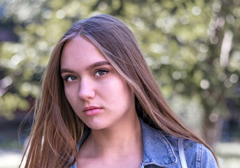 Obraz premium cute young girl 16 years old with long brown hair and brown eyes, close-up portrait