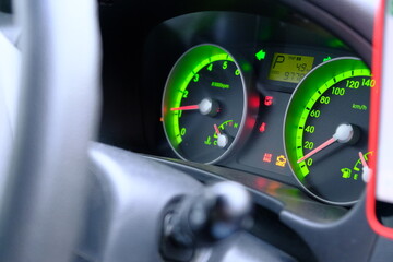 
Car dashboard modern car control with green illuminated speed panel, Highlighted repair icons. Automatic transmission. Auto Navigator on background