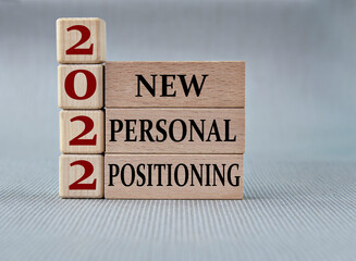 NEW PERSONAL POSITIONING 2022 - words on wooden blocks on gray background