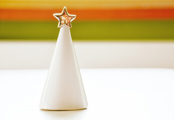 decorative ceramic christmas tree on pastel background closeup