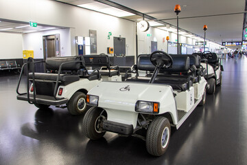 A group of electric vehicles for passengers parked in the corridor of the terminal