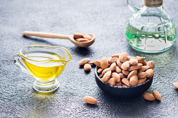 Fresh peeled almonds in a bowl and almond oil on the table. A source of vitamins and oils. Natural cosmetics