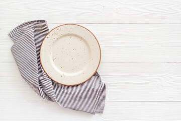 Table setting top view. Empty plate on napkin - dishware for dinner
