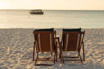 Close-up of sunbeds set on a beautiful tropical beach. Impressive image for every use.