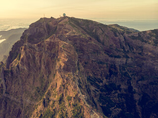 Aerial view of picturesque volcanic mountains at sunrise.