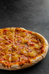 Hawaiian pizza prepared in a wood-fired oven.