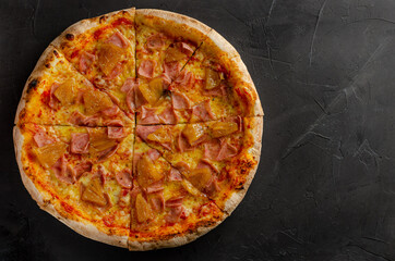 Hawaiian pizza prepared in a wood-fired oven.