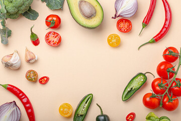 Creative cooking healthy organic food concept background made of colourful fruit and vegetables on beige background flat lay: tomatoes, broccoli, avocado, onion, garlic top view with space for text

