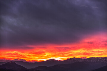 fiery sunset behind the mountains