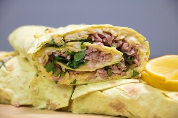 Lavash roll stuffed with sausages, cheese, butter, parsley.