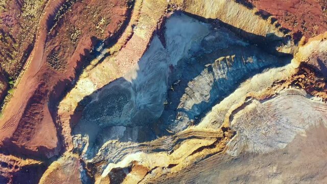 Aerial view down to copper mine open pit site in Cobar town of outback as 4k.
