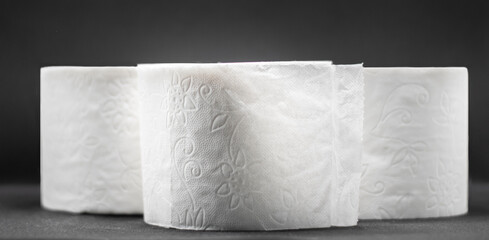 Three rolls of toilet paper isolated with black background