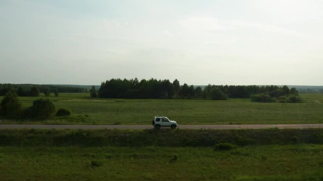 Aerial view of a car driving on a country road