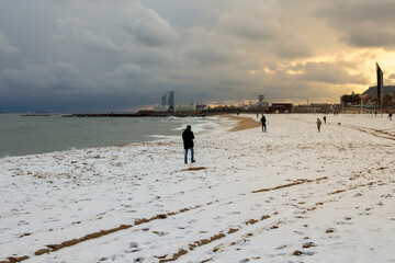 Fototapeta na wymiar snow in the beach in Barceloneta, Barcelona snowy beach Sunset on the beach