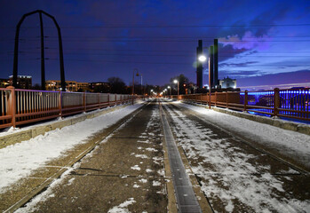 Long urban bridge over the water in winter