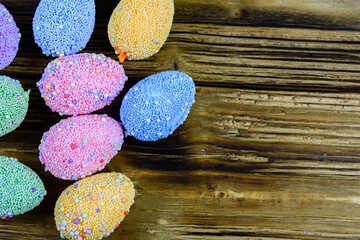 Easter eggs made of styrofoam on a wooden background. Top view