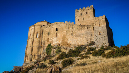 The Castle of Loarre is a Romanesque Castle and Abbey located near the town of the same name in Aragon, Spain. There are great views of the Pyrenees all around it.